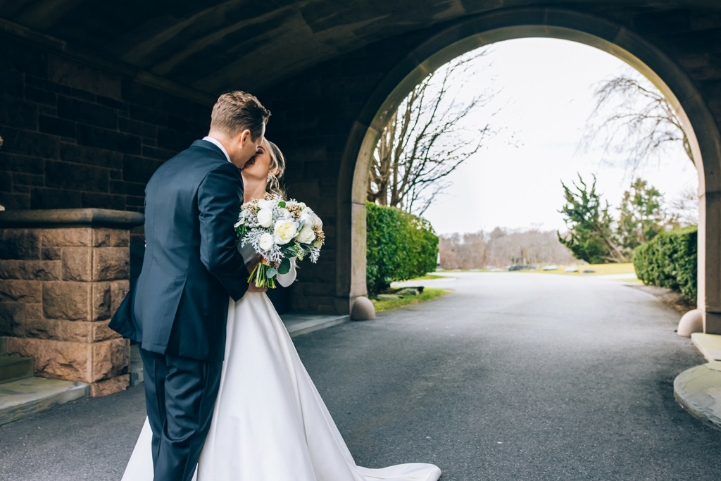 Bride and Groom Kissing Under the OceanCliff Archway